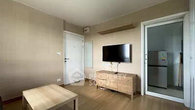 Cozy living room with modern TV setup and wooden furniture