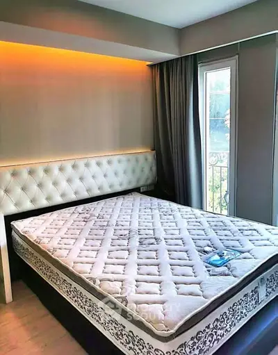 Modern bedroom with elegant lighting and balcony access in a stylish apartment.