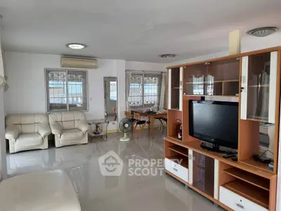 Spacious living room with modern furniture and natural light, perfect for family gatherings.