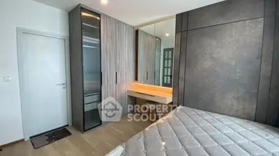 Modern bedroom with stylish wardrobe and cozy bed in elegant apartment