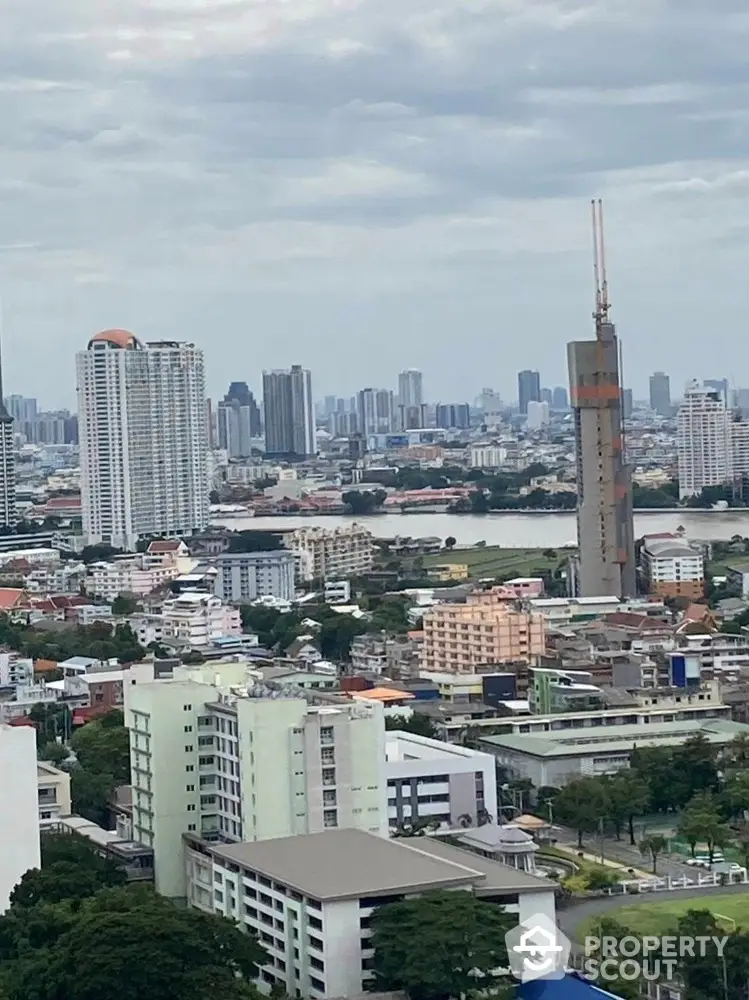 Stunning cityscape view with high-rise buildings and river in vibrant urban setting.