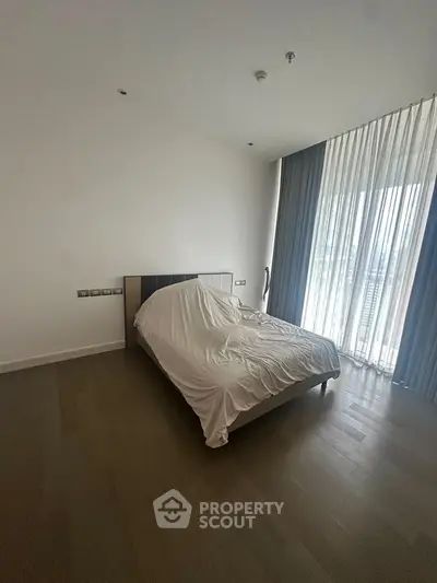 Spacious bedroom with large window and modern design