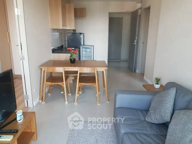 Modern living room with cozy sofa and dining area in open layout apartment.