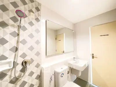 Modern bathroom with geometric tile design and sleek fixtures