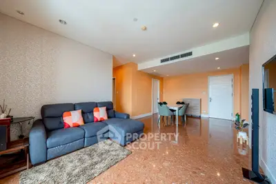 Spacious living room with modern decor and comfortable seating in a luxury apartment.