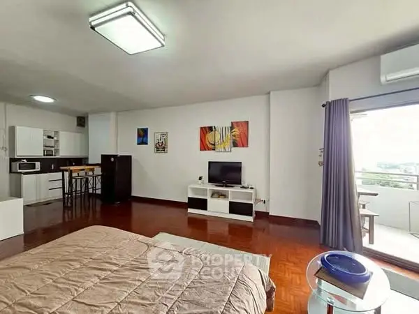 Spacious studio with modern decor and balcony access