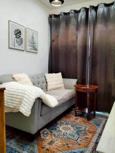 Cozy living room with elegant decor and plush sofa, perfect for relaxation.
