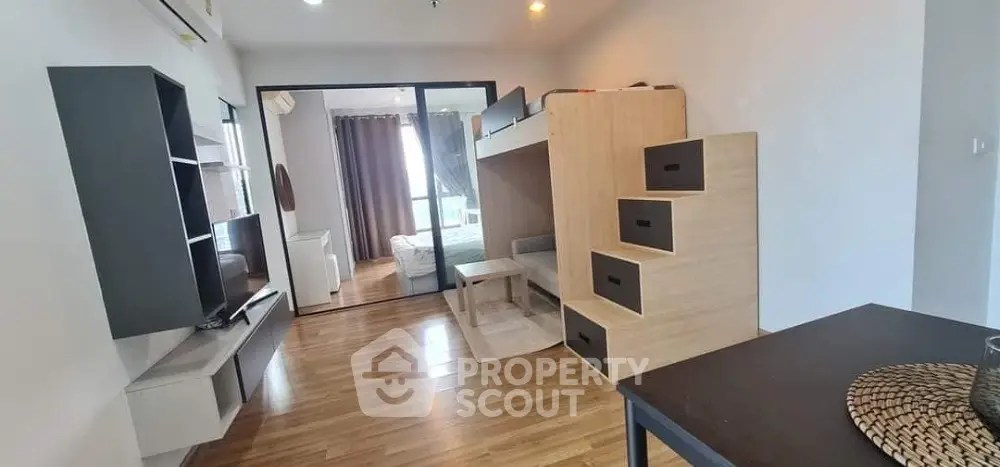 Modern living room with wooden flooring and stylish furniture in a cozy apartment.