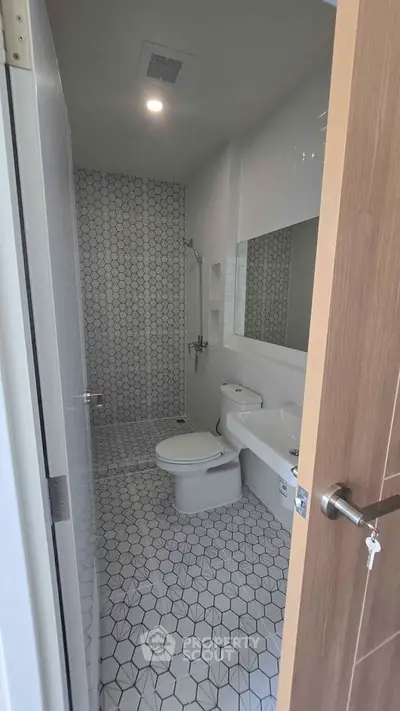 Modern bathroom with sleek hexagonal tiles and contemporary fixtures