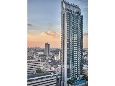 Stunning high-rise building with panoramic city views at sunset, perfect for urban living.