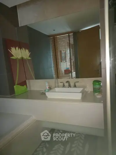 Modern bathroom with sleek sink and stylish decor in a contemporary home.