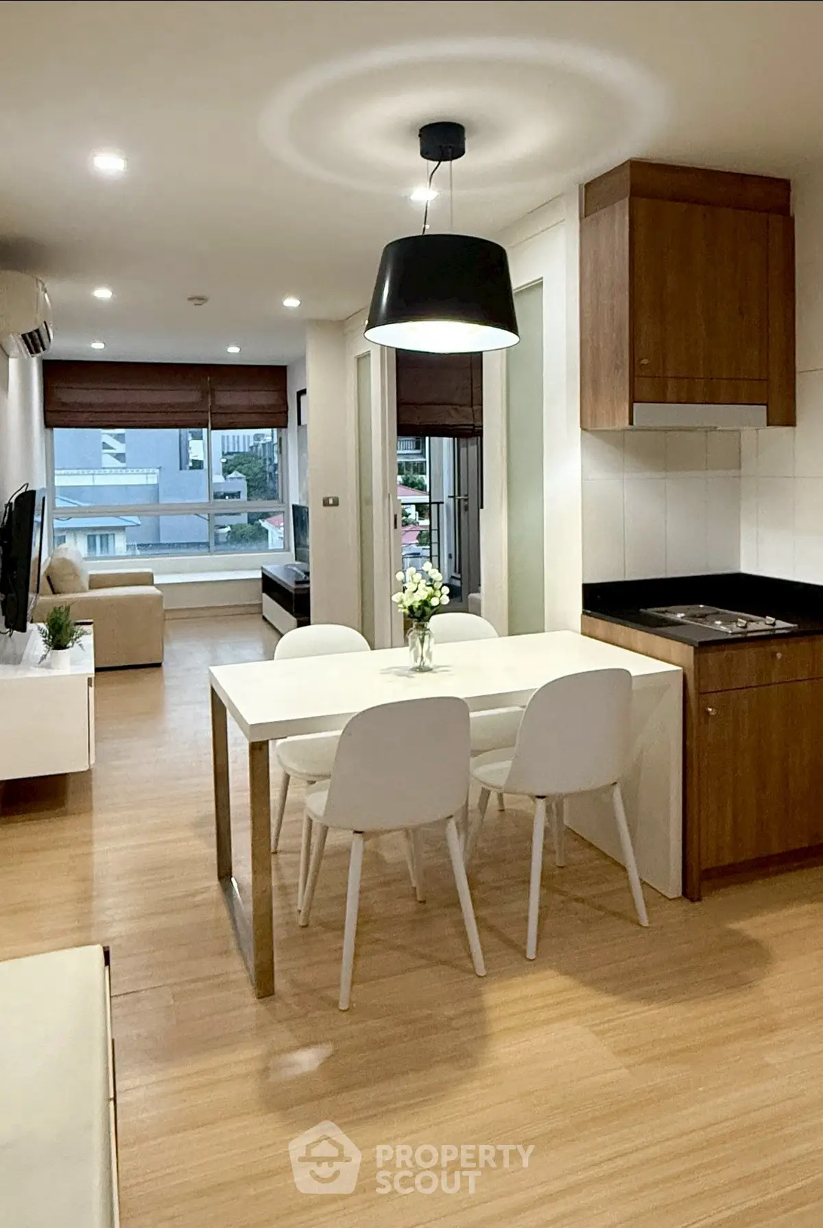 Modern open-plan living room with dining area and stylish lighting