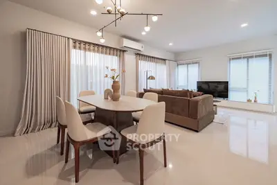 Elegant living room with modern dining area and stylish lighting