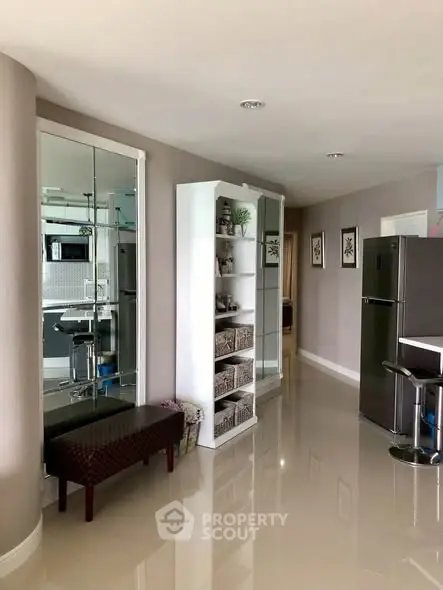 Modern apartment hallway with sleek fridge and stylish shelving unit