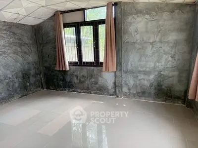 Spacious room with tiled floor and large window, ideal for customization.