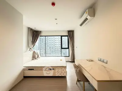 Modern bedroom with large window and air conditioning in high-rise apartment
