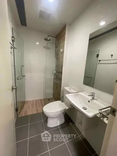 Modern bathroom with sleek shower and contemporary fixtures in a stylish apartment.