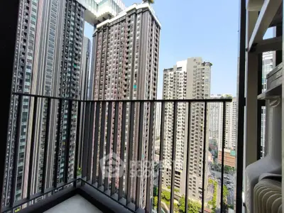 High-rise apartment balcony with stunning cityscape view of modern skyscrapers.