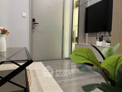 Modern living room with sleek decor and flat-screen TV, showcasing contemporary interior design.