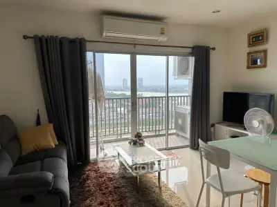 Cozy living room with balcony view, modern furniture, and natural light.