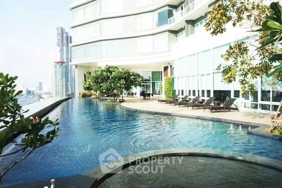 Luxurious high-rise building with stunning infinity pool and city views, perfect for upscale living.