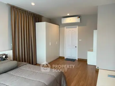 Spacious modern bedroom with sleek design and ample storage