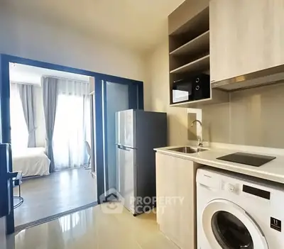 Modern kitchen with washing machine and fridge in a stylish apartment