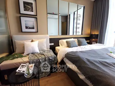 Luxurious modern bedroom with stylish decor and large mirror, perfect for urban living.