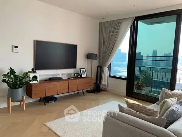 Modern living room with large TV, stylish furniture, and city view balcony.