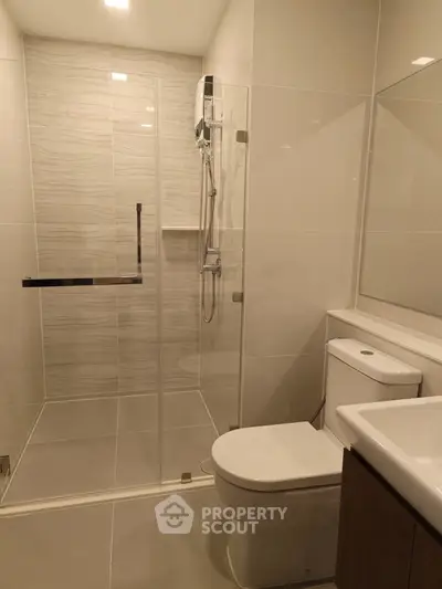 Modern bathroom with glass shower and sleek fixtures