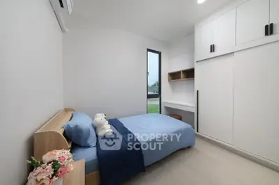 Modern minimalist bedroom with single bed and built-in storage