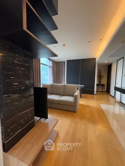 Spacious modern living room with elegant wooden flooring and stylish decor