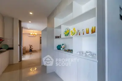 Spacious modern living area with elegant built-in shelving and decorative accents.