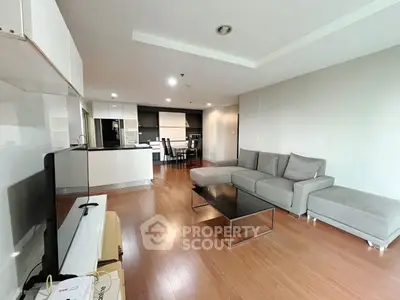 Spacious modern living room with open kitchen and sleek furniture