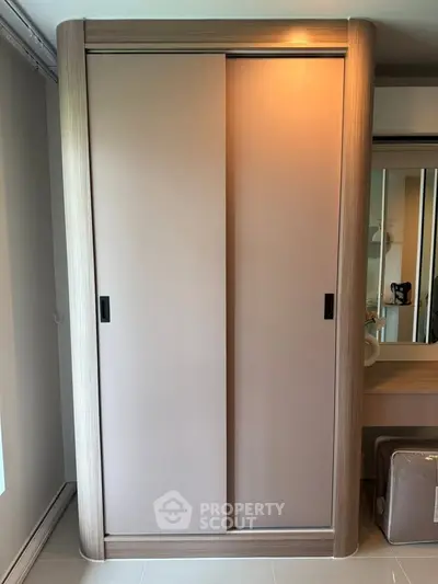 Modern wardrobe with sliding doors in a stylish interior setting