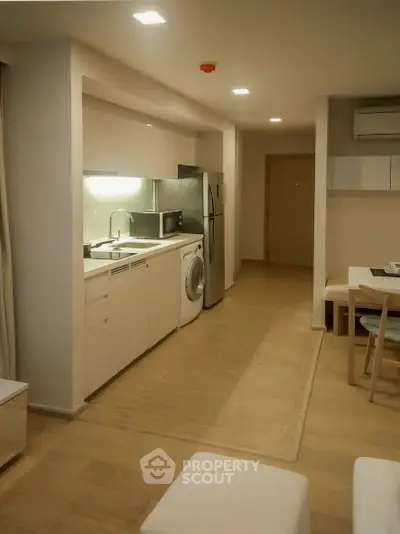 Modern kitchen with sleek appliances and open layout in a cozy apartment.