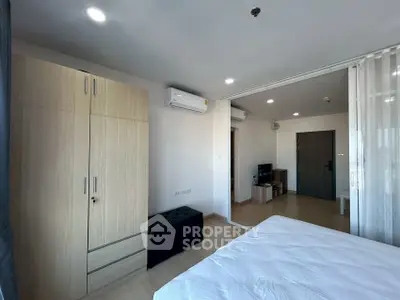 Modern bedroom with wooden wardrobe and air conditioning in stylish apartment.
