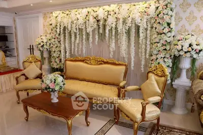 Luxurious living room with elegant gold furniture and floral decor