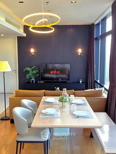 Modern living room with stylish decor, large windows, and dining area, perfect for entertaining.
