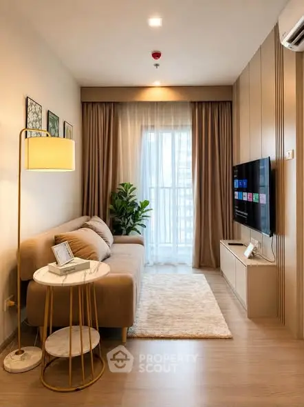Modern living room with cozy sofa, stylish decor, and large window for natural light.