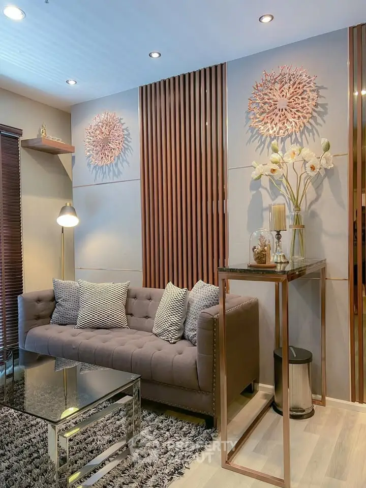 Elegant living room with modern decor, plush sofa, and stylish lighting in a cozy apartment setting.