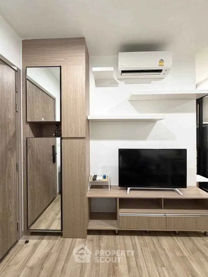 Modern living room with sleek wooden furniture and mounted TV