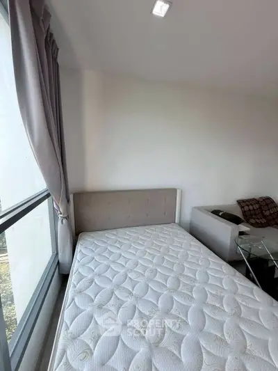 Modern bedroom with large window and stylish decor