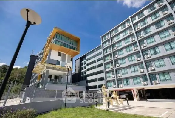 Modern apartment building with unique architectural design and ample windows, ideal for urban living.