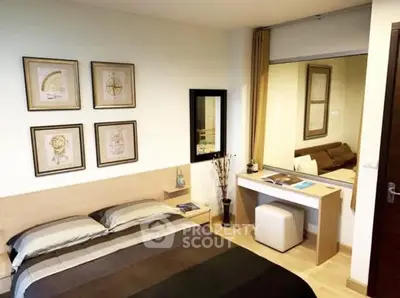 Cozy bedroom with modern decor and stylish artwork, featuring a comfortable bed and elegant furnishings.