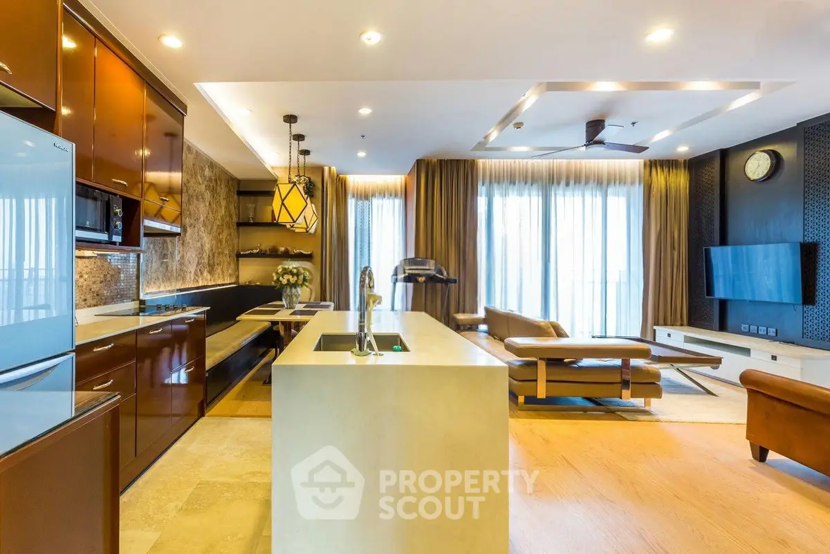 Luxurious open-plan kitchen and living room with modern design and ample natural light.