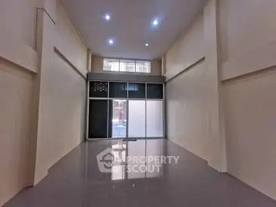 Spacious commercial space with high ceilings and large windows for lease.