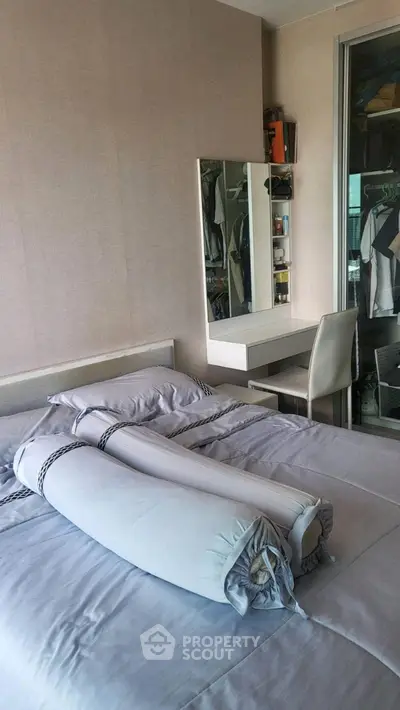 Cozy bedroom with modern decor and built-in closet, perfect for relaxation and comfort.