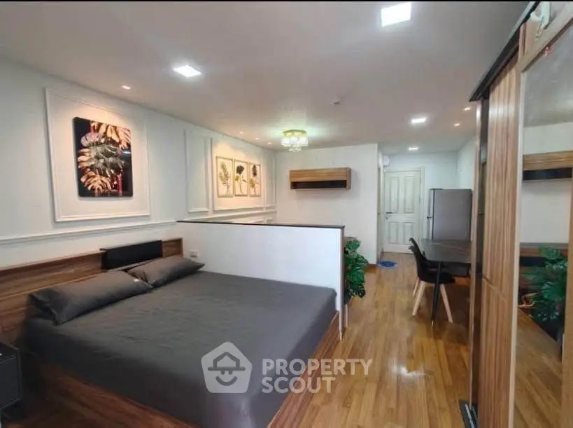 Modern studio apartment with stylish decor and wooden flooring