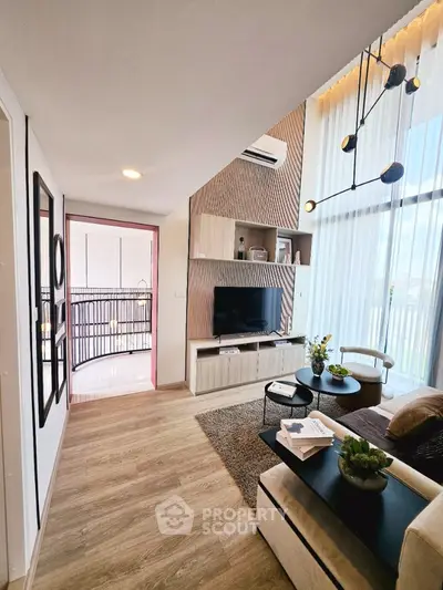 Modern living room with stylish decor and large windows offering natural light